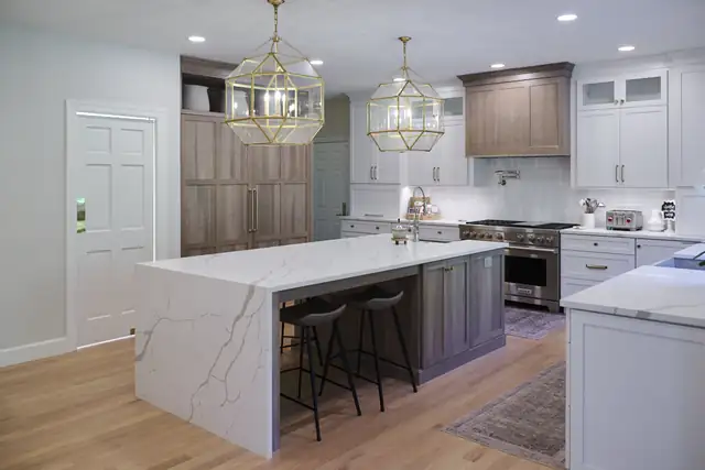 Basement kitchenette with white cabinets, open shelving, gray subway tile and island seating for three